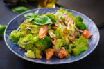 Salad of stewed fish salmon, broccoli, lettuce and dressing fis